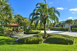 a park with a palm tree and a gazebo at Land's End 8-301 Beach Front in St. Pete Beach