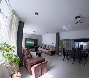 a living room with a couch and a dining room at Departamento amplio y bonito en Arequipa in Arequipa