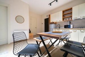a kitchen and dining room with a table and chairs at Zarku Apartments in Bakuriani