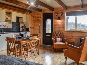 a kitchen and dining room with a table and chairs at Glenkens Lodge in Dalry