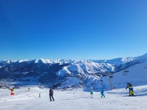 a group of people skiing on a ski slope at Saint lary soulan village T2 Avec parking in Saint-Lary-Soulan