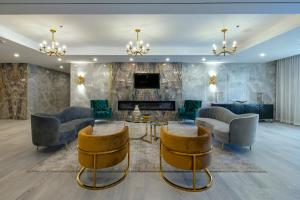 a living room with chairs and a fireplace at Halifax Tower Hotel & Conference Centre, an Ascend Collection Hotel in Halifax