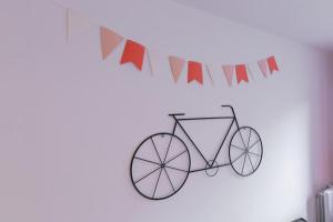dessin d'un vélo sur un mur avec drapeaux dans l'établissement Cabana & L' Horeb - Hypercentre, à Paray-le-Monial