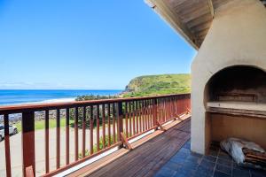 a balcony with a view of the ocean at Mitford Memories in Morganʼs Bay