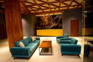 a living room with two blue couches and a coffee table at Marika's Valley in Bakuriani