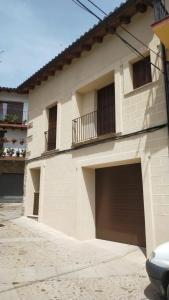 a house with two garage doors and a balcony at CASA RURAL LA MANFORTA in Gata