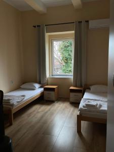 a room with two beds and a window at DND-X in Pančevo