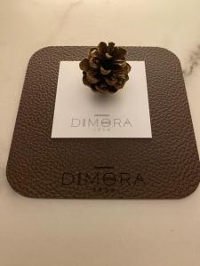 a plaque with a pine cone on top of it at DIMORA1934 Relax&Comfort in Tirano