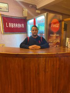 a man sitting at a bar in a restaurant at La Baraka Auberge in Aït Benhaddou +64 photos