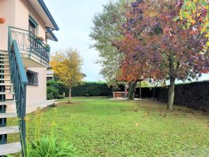 un patio con un árbol y una valla en GIOIA NELLE SELVE Family House - Casa Vacanze, en Mogliano Veneto
