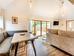 a living room with a couch and a table at Tawny Acre Barn - Uk38614 in Wisbech