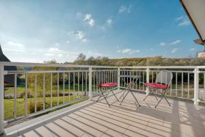 a balcony with two chairs and a view at ASTAREA - penthouse in green & nature - hot tub - free private parking - terrace - peace in Zagreb