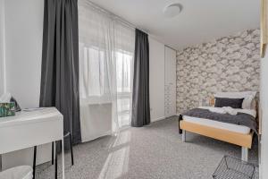 een slaapkamer met een bed en een groot raam bij ASTAREA - penthouse in green & nature - hot tub - free private parking - terrace - peace in Zagreb