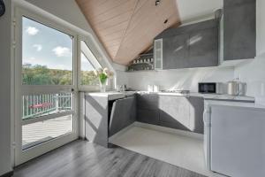 A kitchen or kitchenette at ASTAREA - penthouse in green & nature - hot tub - free private parking - terrace - peace
