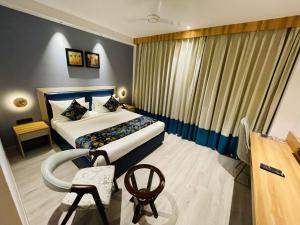 En eller flere senge i et værelse på Hotel Malbork Inn @ Janakpuri
