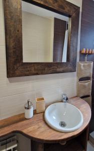 a bathroom with a sink and a mirror at Apartamento centro de Sallent con WIFI in Sallent de Gállego