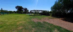 a park with a swing set in the grass at Paraiso del Sol in San Rafael