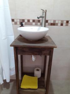 a white sink on a wooden table in a bathroom at Terra Apart in Chivilcoy
