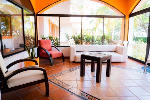 a living room with a couch and a table and chairs at Hotel Peñon Suites in Girardot