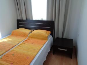 a small bedroom with a bed and a night stand at Apartment N4 in Sunset Beach 2,Слънчев бряг in Sunny Beach