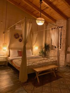 a bedroom with a canopy bed and a table at Hera Hotels Alaçatı in Cesme