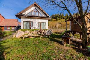 a small house with a bench in front of it at Chata Zdiarka 4M in Ždiar