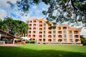 a large building with a park in front of it at Hotel Peñon Suites in Girardot