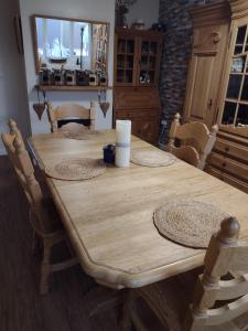 a wooden table in a kitchen with chairs and a tableablish at Little Bassett Bed & Breakfast in Totland