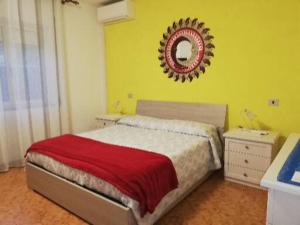 1 dormitorio con cama y espejo en la pared en A Domo Mia, en Castelsardo