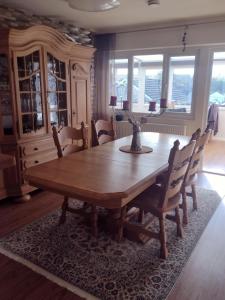 a dining room with a wooden table and chairs at Little Bassett Bed & Breakfast in Totland