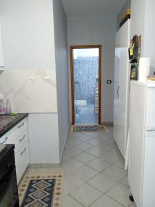 a kitchen with a sink and a refrigerator at Apartment Durres in Durrës