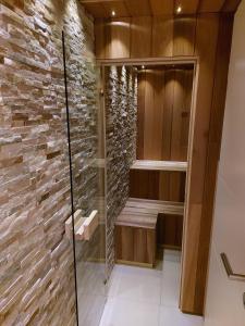 uma cabina de duche ao nível do chão com uma parede de pedra em Holiday Home Mooi-Gemmenich em Plombières