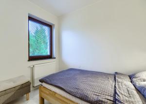 a bedroom with a bed and a window at Studio Gdańsk - Oliwa in Gdańsk
