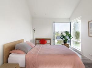 a bedroom with a large bed and a large window at Modern Luxury Apartment - Ocean & Mountain Views in Reykjavík +12 photos