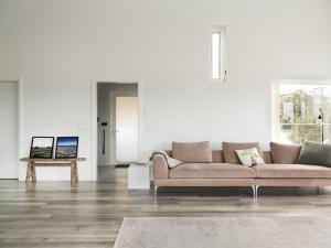 a living room with a couch and a table at Modern Luxury Apartment - Ocean & Mountain Views in Reykjavík