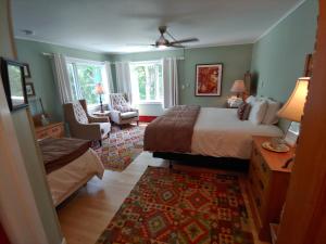 a bedroom with a bed and a living room at Keene Valley Lodge in Keene Valley