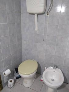 a small bathroom with a toilet and a sink at Casa en La Esmeralda Uruguay in La Esmeralda 