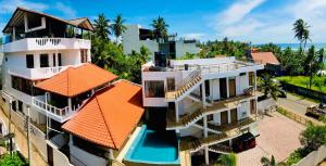 an aerial view of a building with an orange roof at Resort Deepika Mirissa in Mirissa