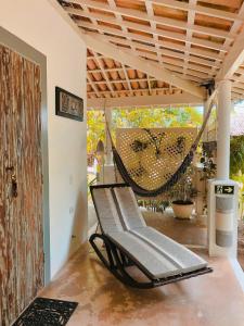 a hammock in a room with a patio at CASA ACAYU in São Miguel dos Milagres
