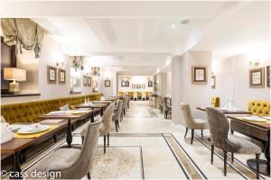 a dining room with long tables and chairs at Hotel Versay in Băile Herculane