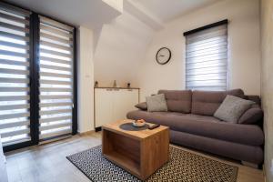 a living room with a couch and a coffee table at Apartman Maslacak in Divčibare