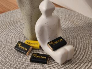 a statue of a person with three pieces of chocolate at Apartman Maslacak in Divčibare