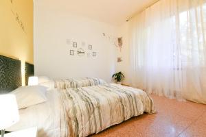 מיטה או מיטות בחדר ב-We Home - Dall'ARA57 - Bologna Stadium
