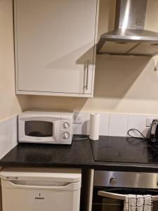a kitchen with a microwave on a counter at Chique Maidstone Studio III in Kent