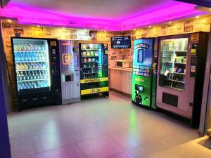 a arcade with three vending machines in a room at Barak Royal Suites VIP 94 - חמש דקות מהים ומהטיילת in Eilat