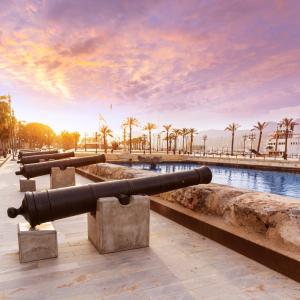 a row of cannons in front of a body of water at CARTAGENAFLATS, Apartamentos Anfiteatro Romano 4C in Cartagena