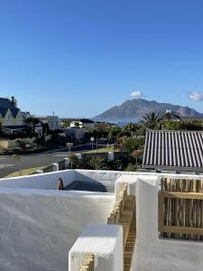 a white building with a view of the ocean at Rest@Kommetjie in Cape Town