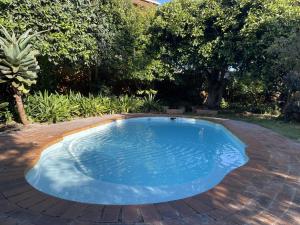 a small swimming pool on a brick patio at Rest@Kommetjie in Cape Town
