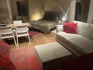 a living room with a couch and a bed at Canal Central in Bruges