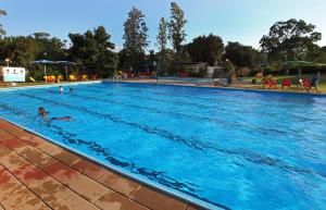 a large swimming pool with people in the water at Etnachta Kibbutz Afik in Afik
